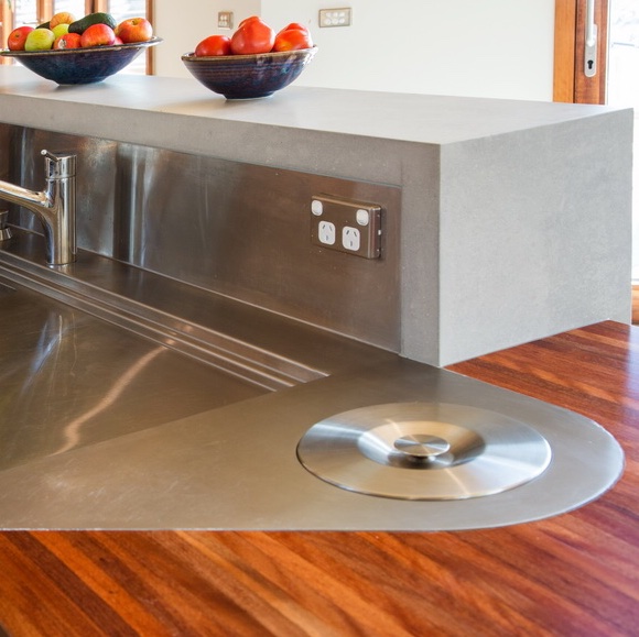 Curved recycled timber and plywood kitchen.