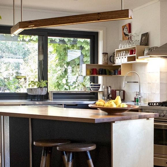 Plywood Pezzo and black Paperock custom kitchen.